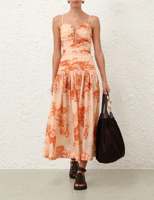 Peach floral print strapless midi dress with ruched bodice and gathered skirt, styled with black sandals and bag — Zimmermann | Endless UAE