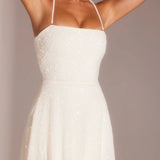 White halter A-line mini dress with embellished detail on model wearing metallic sandals — Oh Polly | Endless UAE