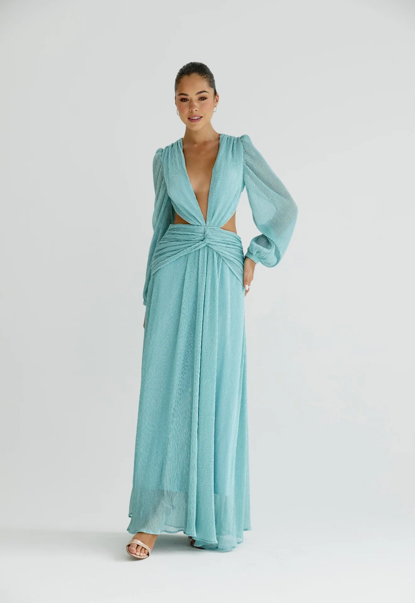 Woman wearing a flowing light blue wrap dress with long sleeves and cutout waist detail — Anne Louise Boutique | Endless UAE