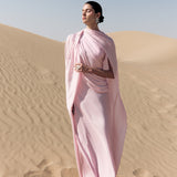 Woman wearing pink textured maxi dress in desert setting — Lichi | Endless UAE