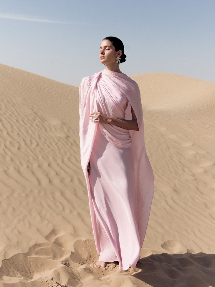 Woman wearing pink textured maxi dress in desert setting — Lichi | Endless UAE