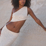 Ivory sequin one-shoulder crop top and maxi skirt set worn on coastal rocks at sunset — Label Loft London | Endless UAE
