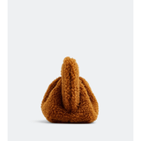 Gea Clutch in caramel brown textured fabric held in hand — TheMoire | Endless UAE