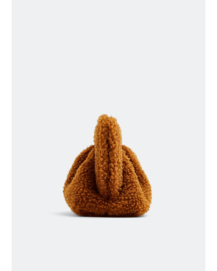 Gea Clutch in caramel brown textured fabric held in hand — TheMoire | Endless UAE