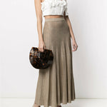 White halter crop top with ruffled floral appliqué detail and neck tie, paired with metallic pleated maxi skirt — Zimmermann | Endless UAE