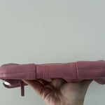 Pink leather mini shoulder bag with dual handles displayed against neutral background — By Far | Endless UAE