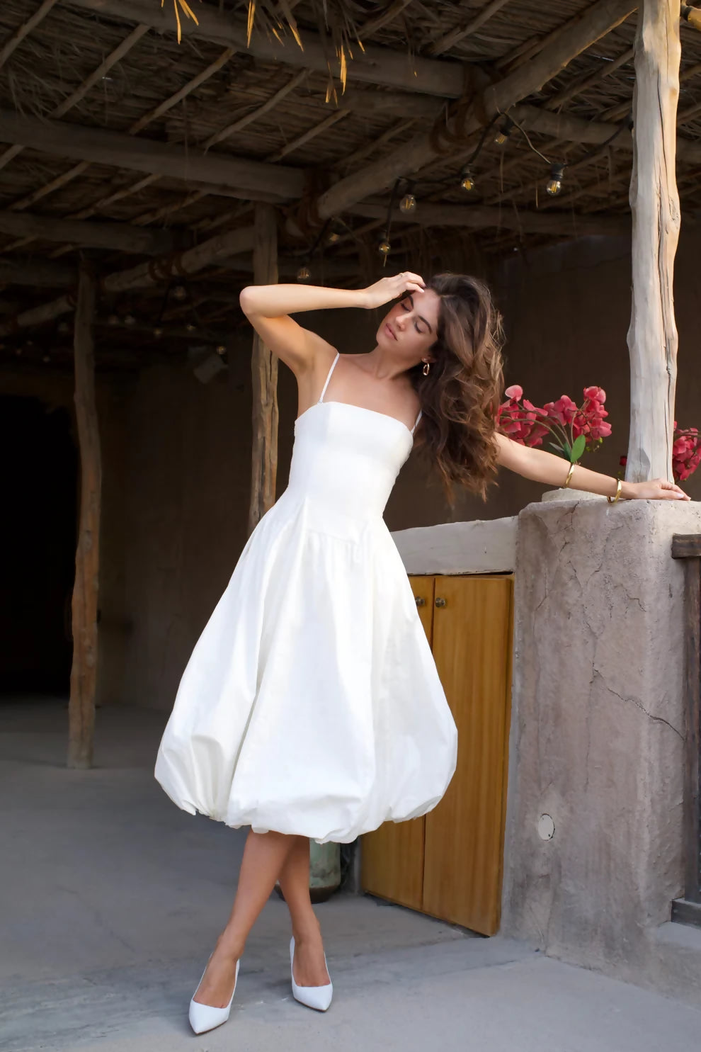 Elegant white bubble hem midi dress with thin straps and fitted bodice in rustic setting — Cleopatress | Endless UAE
