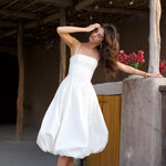 Elegant white bubble hem midi dress with thin straps and fitted bodice in rustic setting — Cleopatress | Endless UAE