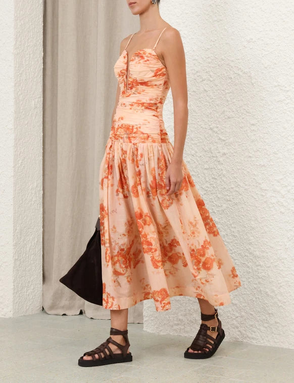 Peach floral print strapless midi dress with ruched bodice and gathered skirt, paired with black sandals — Zimmermann | Endless UAE