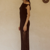 Woman wearing black off-shoulder knit maxi dress with fringe hem and white bangles — Endless | Endless UAE