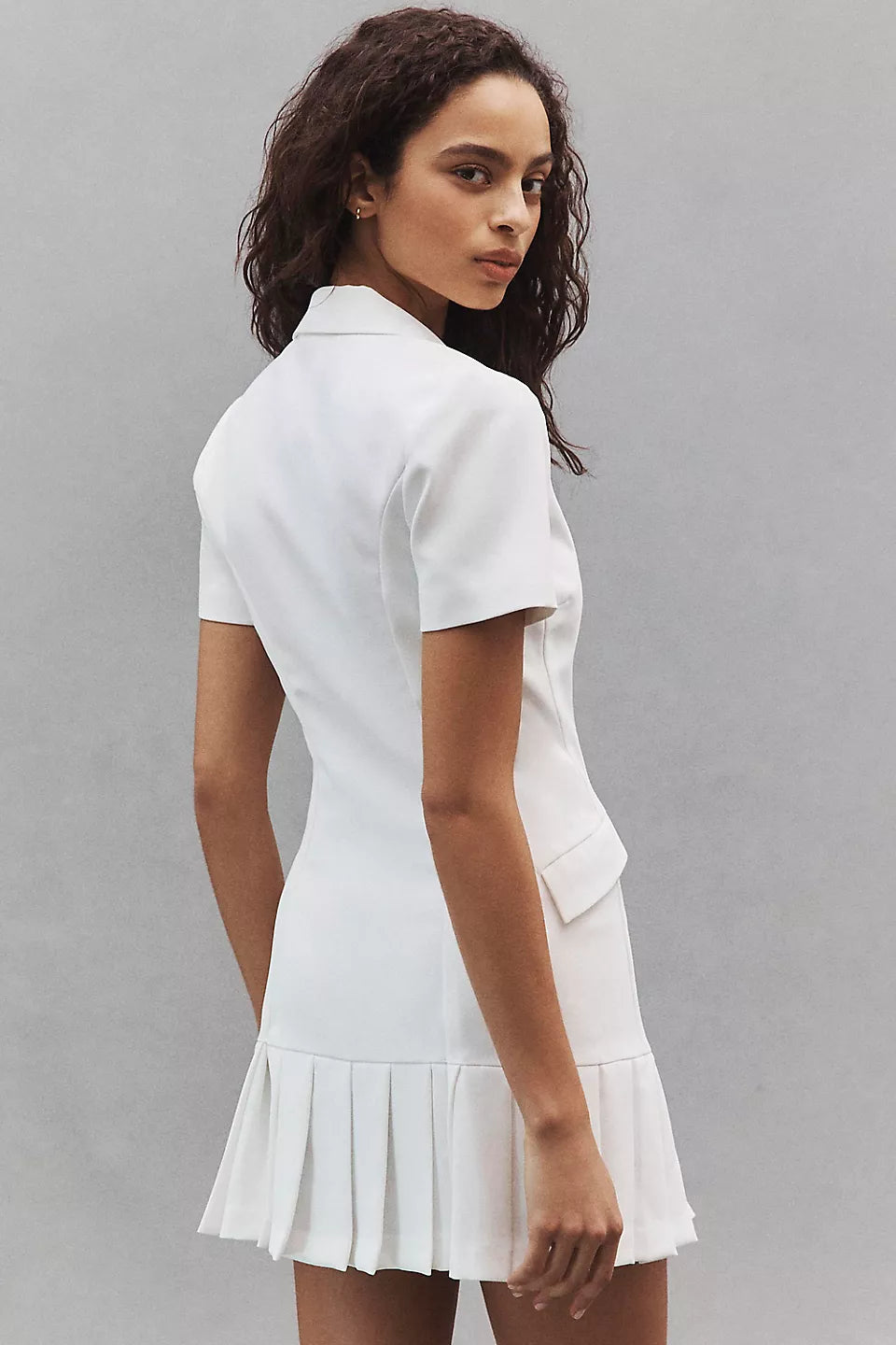 White collared mini dress with short sleeves and pleated hem worn by model — Amanda Uprichard | Endless UAE