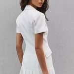White collared mini dress with short sleeves and pleated hem worn by model — Amanda Uprichard | Endless UAE