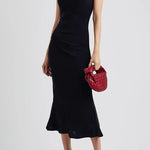 Black one-shoulder velvet midi dress with red quilted bag and gold heeled sandals — Misha | Endless UAE