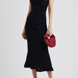 Black one-shoulder velvet midi dress with red quilted bag and gold heeled sandals — Misha | Endless UAE