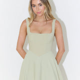 Woman wearing sage green square neck midi dress with full skirt and pockets — Odd Muse | Endless UAE