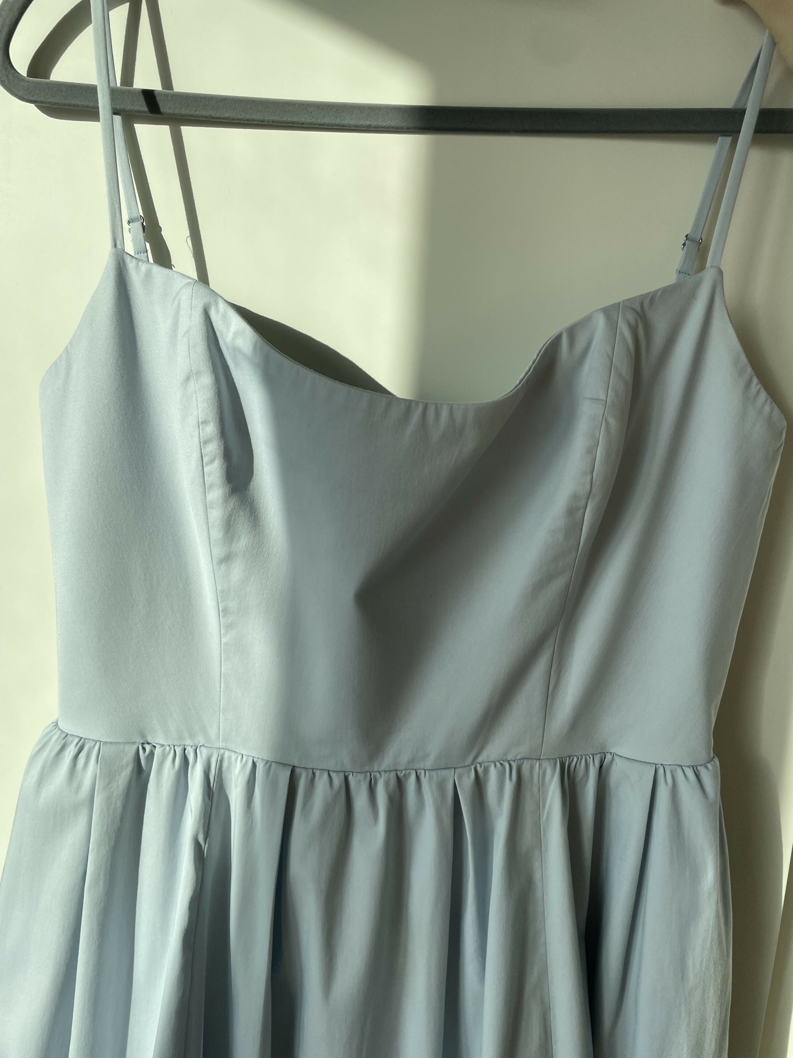 Woman wearing light blue sleeveless midi dress with corset top and full skirt — Endless | Endless UAE