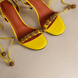 Bright yellow strappy heels with gold glitter embellishments and ankle ties — Subashini Heels | Endless UAE