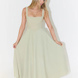 Woman wearing sage green square neck midi dress with full skirt and pockets — Odd Muse | Endless UAE