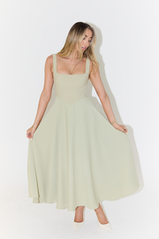 Woman wearing cream square neck midi dress with flowing skirt and white heels — Odd Muse | Endless UAE