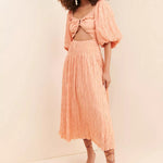 Peach crinkle textured reversible midi dress with puff sleeves, cutout waist and flowing pleated skirt — Soverè | Endless UAE