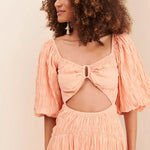 Peach textured midi dress with bow cutout detail and puff sleeves — Soverè | Endless UAE