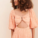 Peach textured midi dress with bow cutout detail and puff sleeves — Soverè | Endless UAE