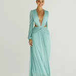 Woman wearing a flowing light blue wrap dress with long sleeves and cutout waist detail — Anne Louise Boutique | Endless UAE