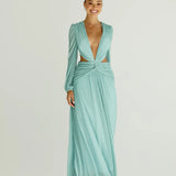 Woman wearing a flowing light blue wrap dress with long sleeves and cutout waist detail — Anne Louise Boutique | Endless UAE