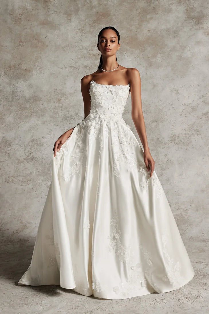 Elegant strapless ivory ball gown wedding dress with floral lace appliqués and full skirt — Justin Alexander | Endless UAE