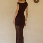 Woman wearing black off-shoulder knit maxi dress with fringe hem and white bangles — Endless | Endless UAE