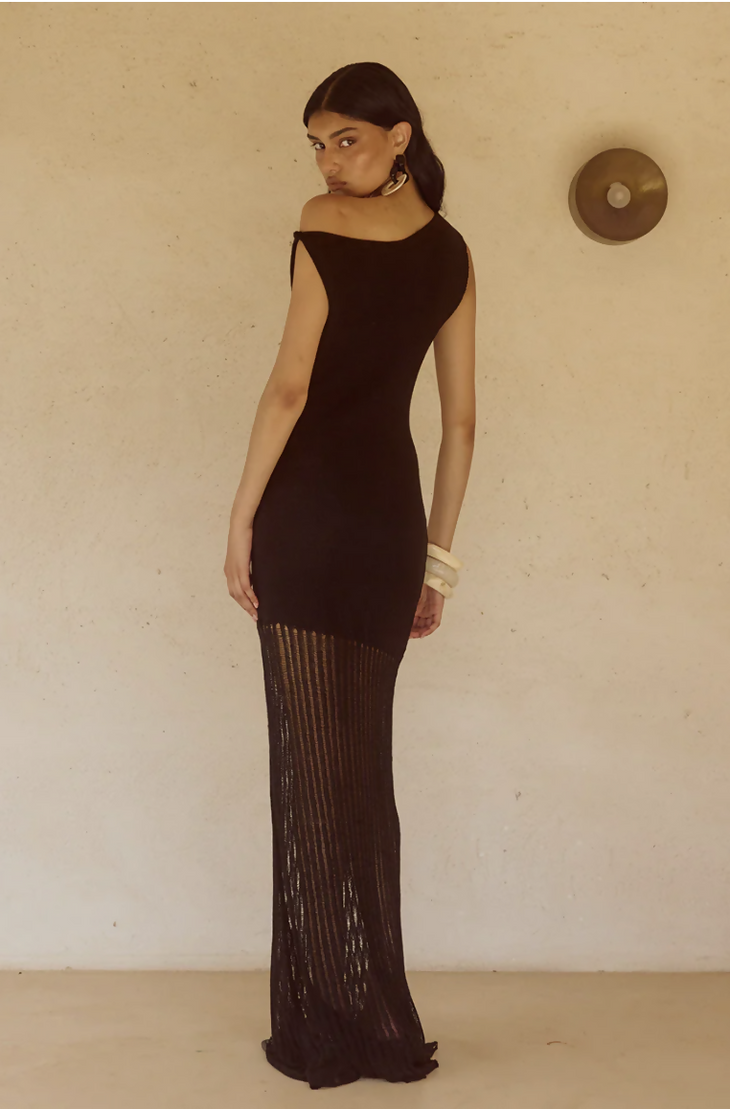 Woman wearing black off-shoulder knit maxi dress with fringe hem and white bangles — Endless | Endless UAE
