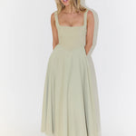 Woman wearing sage green square neck midi dress with full skirt and pockets — Odd Muse | Endless UAE