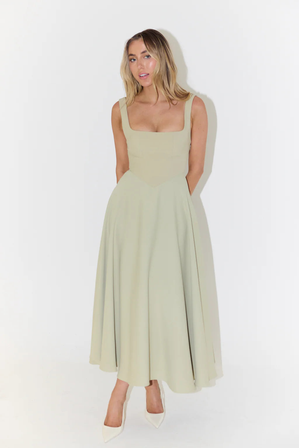 Woman wearing sage green square neck midi dress with full skirt and pockets — Odd Muse | Endless UAE