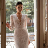 Elegant white lace wedding dress with long sleeves and flowing tulle train — Tatiana Kaplun | Endless UAE
