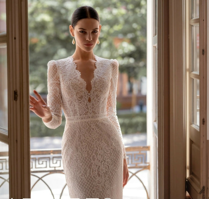 Elegant white lace wedding dress with long sleeves and flowing tulle train — Tatiana Kaplun | Endless UAE