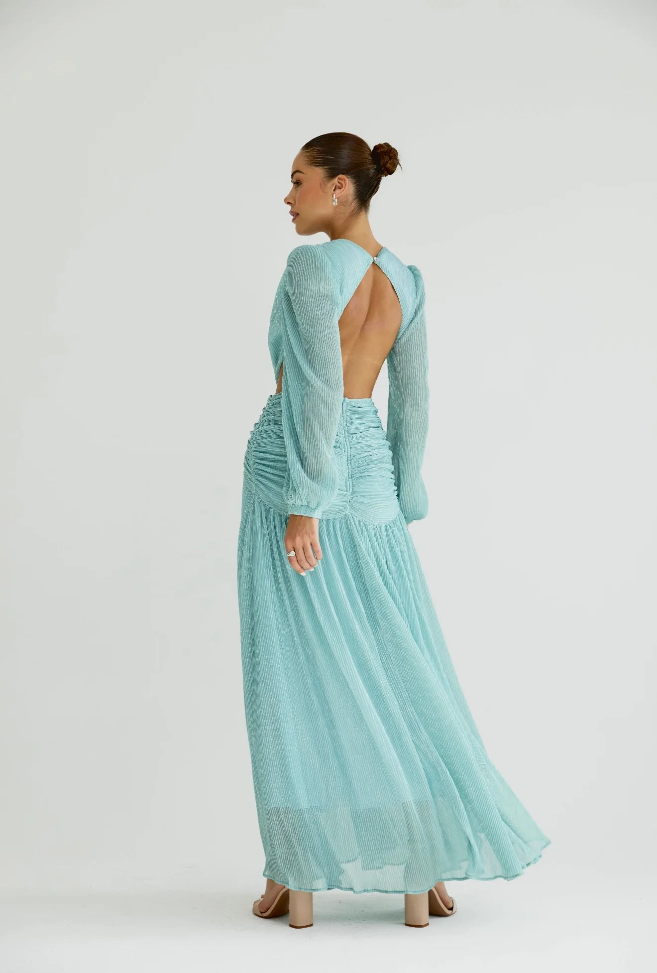 Woman wearing a flowing light blue wrap dress with long sleeves and cutout waist detail — Anne Louise Boutique | Endless UAE