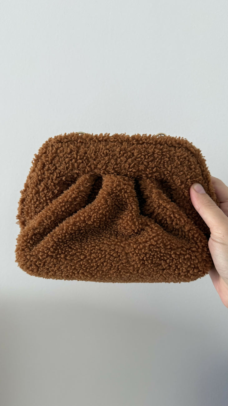 Gea Clutch in caramel brown textured fabric held in hand — TheMoire | Endless UAE