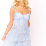 Blonde woman wearing light blue lace maxi dress with corset bodice and ruffled straps against white background — Amy Jane London | Endless UAE
