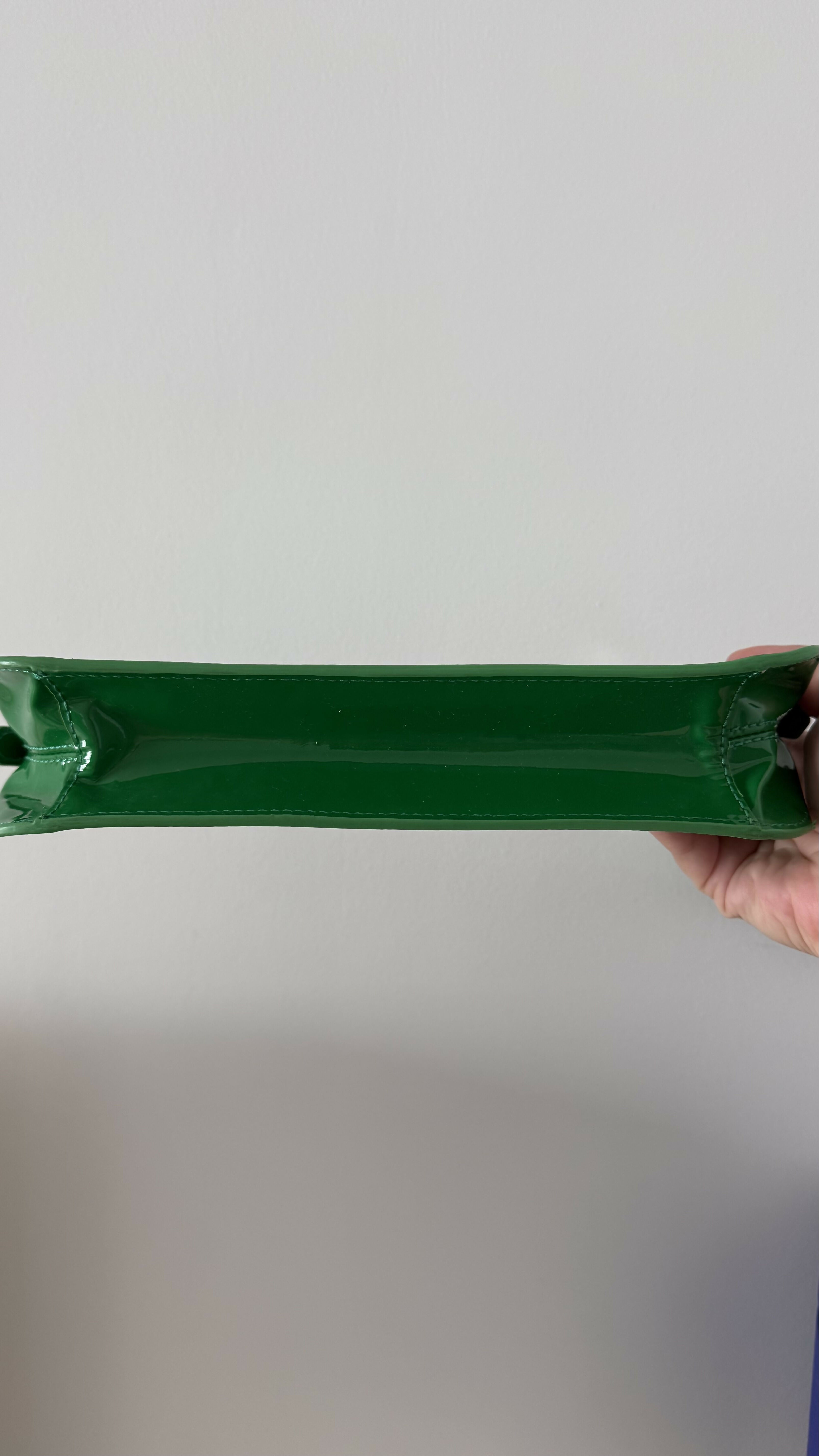 Dulce Patent Leather Shoulder Bag in vibrant green, held up against neutral background — By Far | Endless UAE