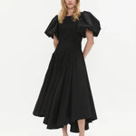 Woman wearing black Wisteria Cotton Midi Dress with puffed sleeves and asymmetrical hem — Aje | Endless UAE