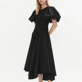 Woman wearing black Wisteria Cotton Midi Dress with puffed sleeves and asymmetrical hem — Aje | Endless UAE