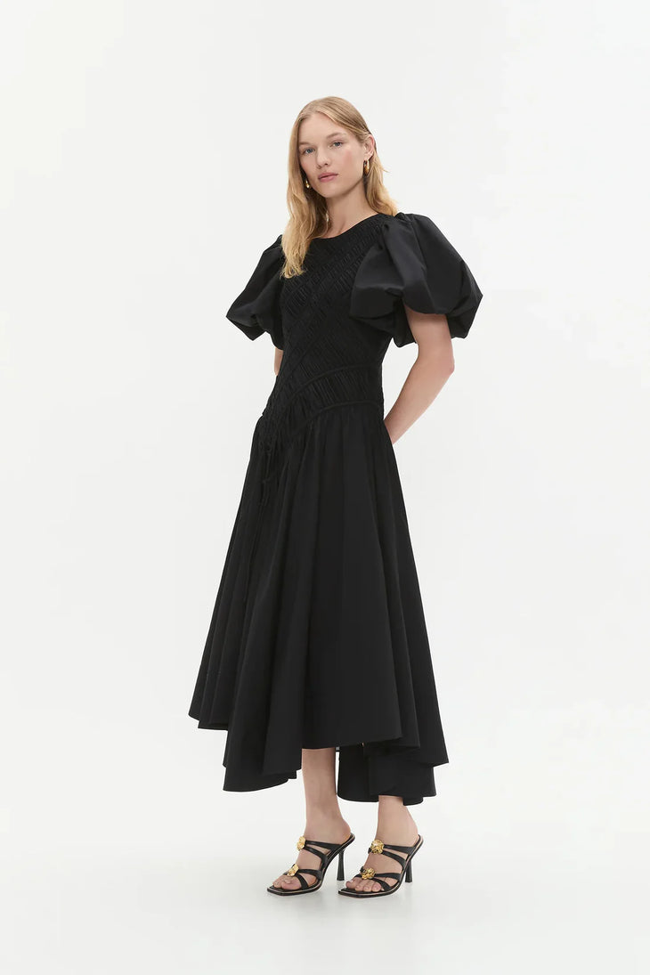 Woman wearing black Wisteria Cotton Midi Dress with puffed sleeves and asymmetrical hem — Aje | Endless UAE