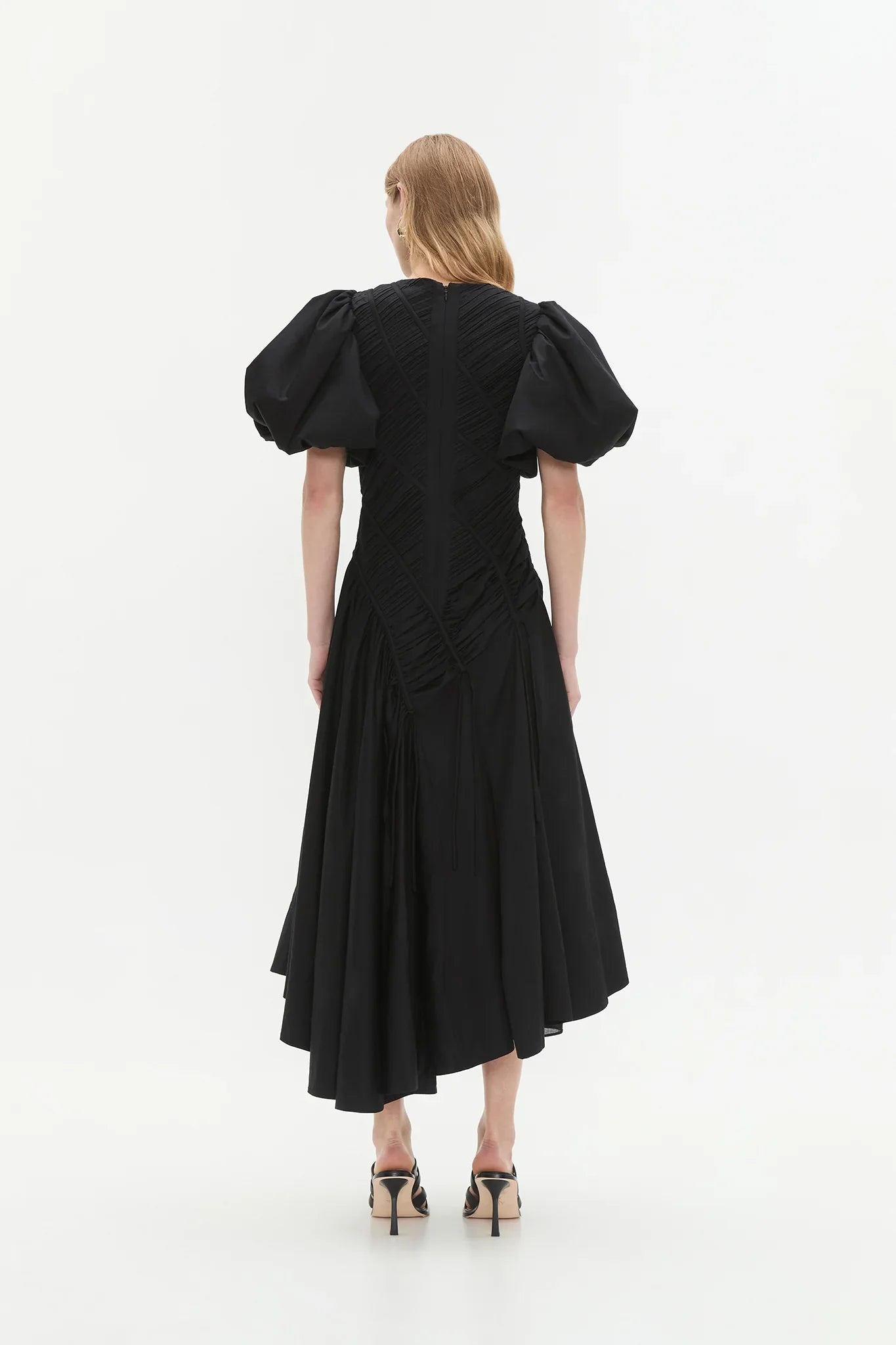 Woman wearing black Wisteria Cotton Midi Dress with puffed sleeves and asymmetrical hem — Aje | Endless UAE