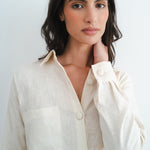 Woman wearing cream linen shirt with button details and chest pocket from relaxed Cassidy Set — Amara Grace | Endless UAE