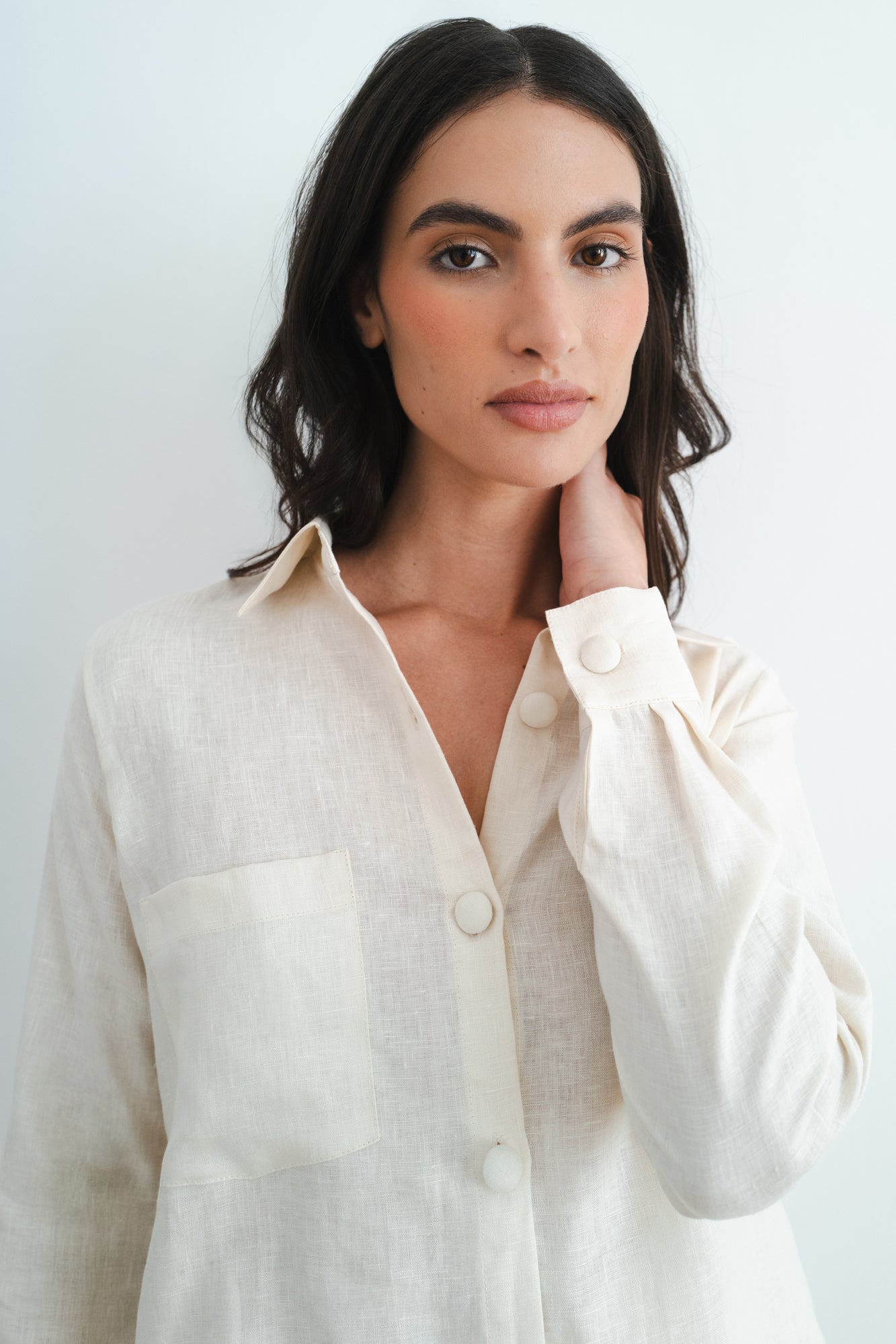 Woman wearing cream linen shirt with button details and chest pocket from relaxed Cassidy Set — Amara Grace | Endless UAE
