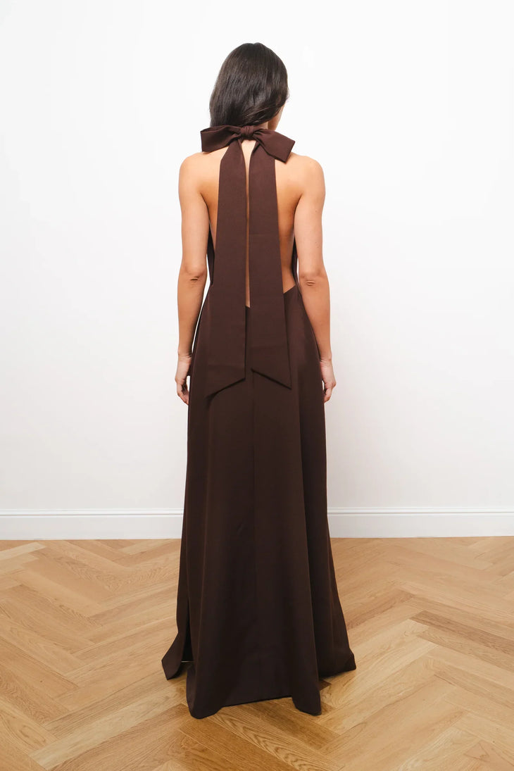 Elegant brown halter maxi dress with bow tie detail at neck, shown from back view — Amara Grace | Endless UAE