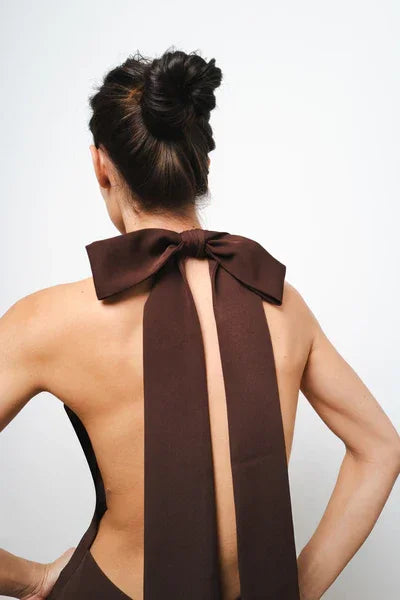 Elegant brown backless maxi dress with statement bow tie at neckline and dramatic back detail — Amara Grace | Endless UAE