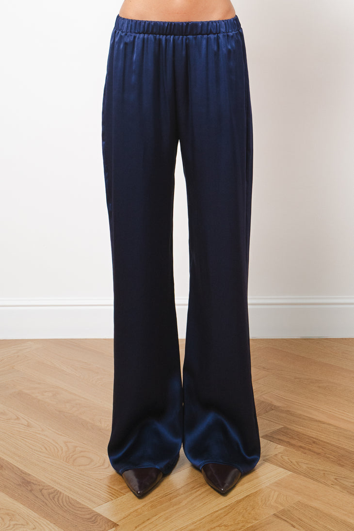 Navy blue silk wide-leg trousers with elastic waistband, full-length hem, worn with pointed heels — Amara Grace | Endless UAE