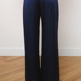Navy blue silk wide-leg trousers with elastic waistband, rear view on model — Amara Grace | Endless UAE