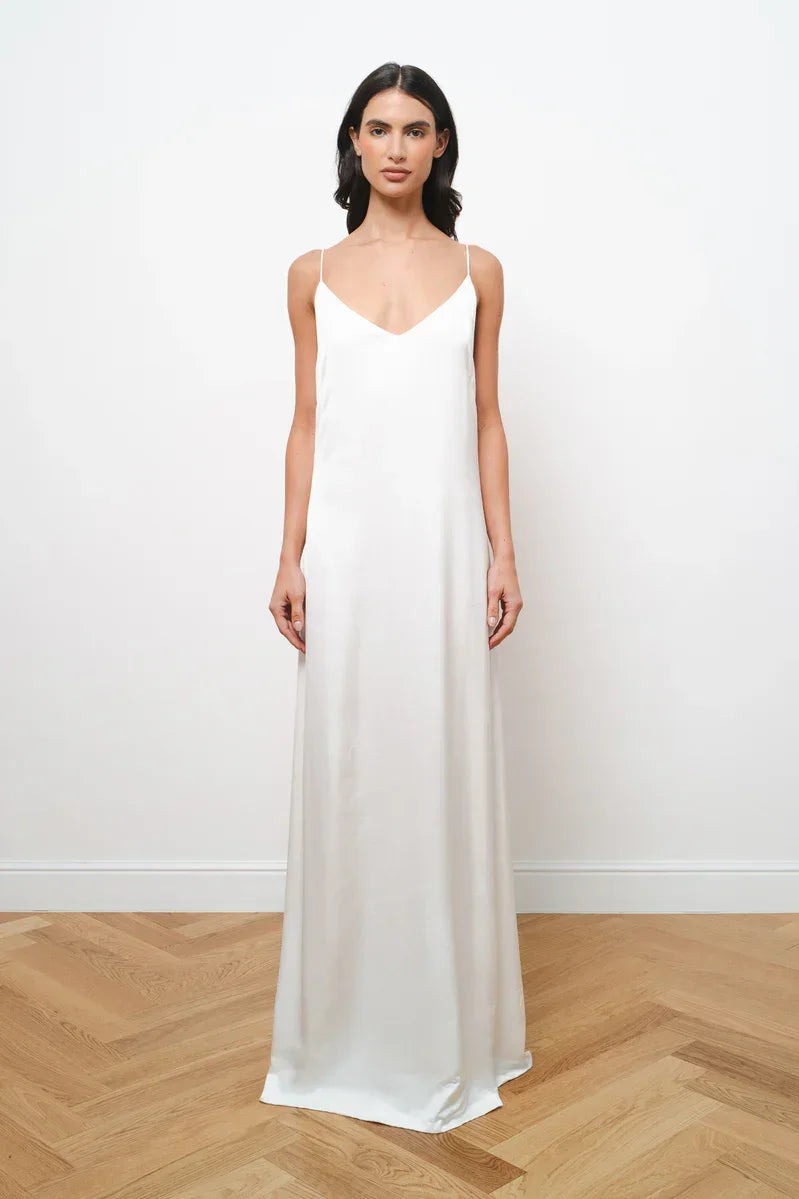 Elegant white maxi dress with thin spaghetti straps and V-neckline in flowing silhouette — Amara Grace | Endless UAE